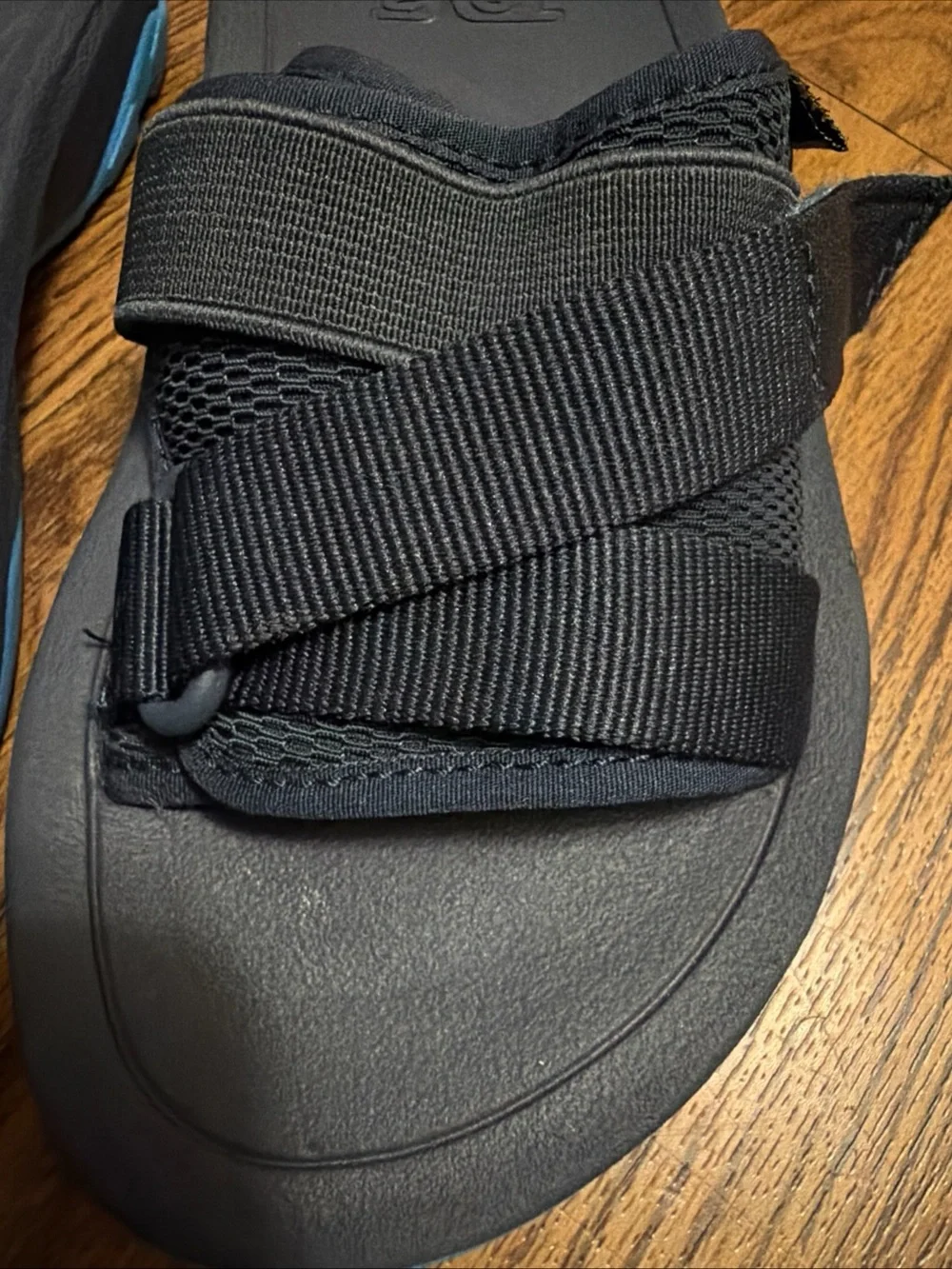 Teva Black Slide Sandals with Blue Accent
